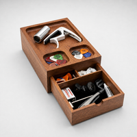 Thumbnail for A wooden multi-compartment storage box with an open drawer, containing small accessories such as a metal cylinder, a white clamp-like tool, colorful discs, and black and white items, photographed on a light gray background.

